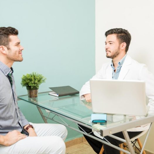 profile-view-young-male-nutritionist-talking-patient-his-office-health-spa-clinic_662251-2602